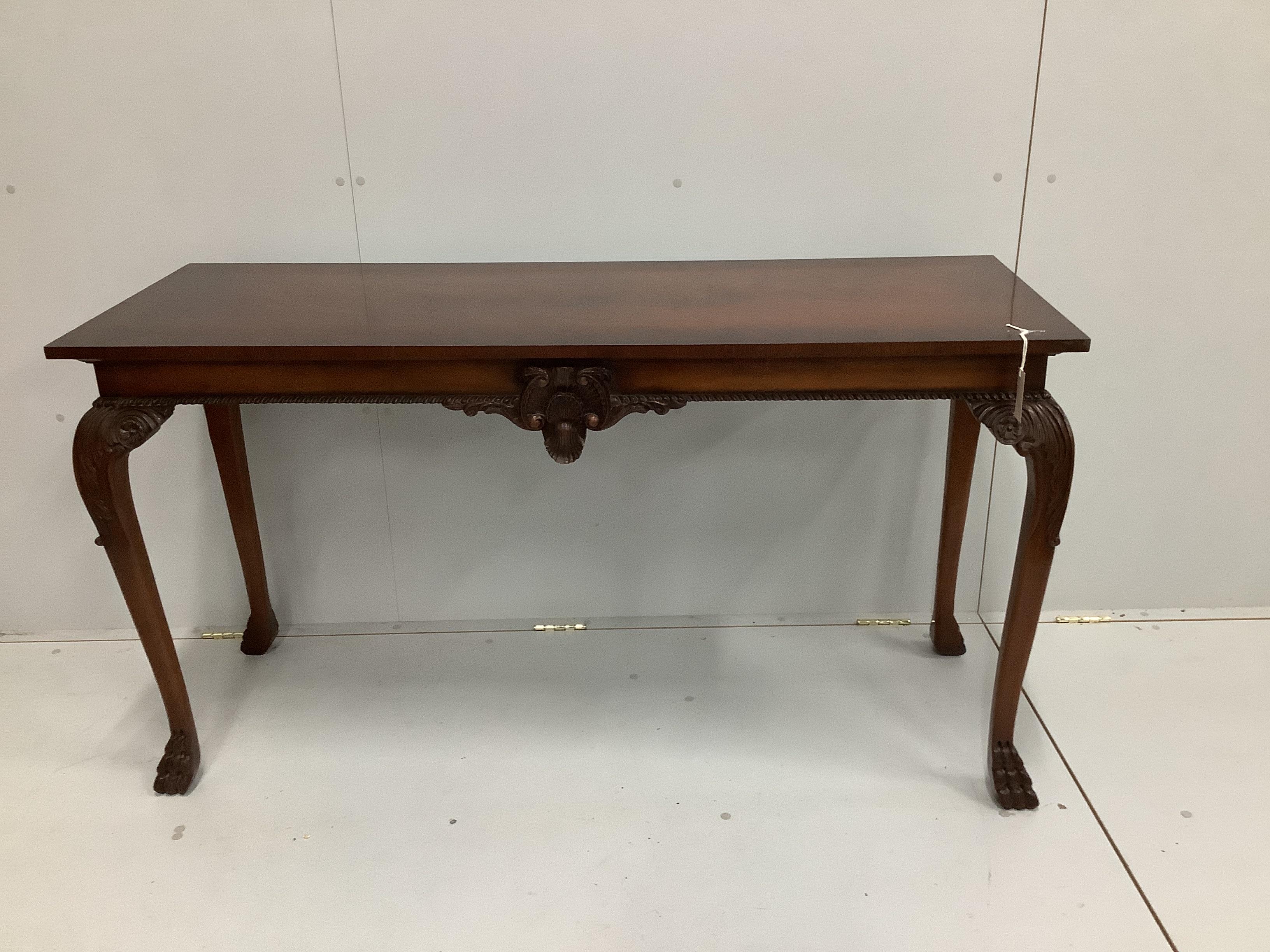 A reproduction George III style mahogany console table, with carved frieze, on cabriole legs, length 142cm, depth 51cm, height 79cm